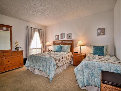a bedroom with two beds and a dresser and a window at 440 West Condos 1508S Walk to the Beach 555 in Clearwater Beach
