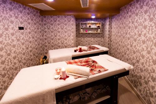 two beds in a room with purple wallpaper at Antusa Design Hotel & Spa in Istanbul