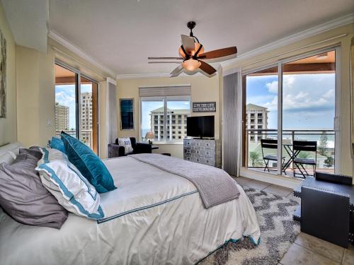 a bedroom with a large bed with a ceiling fan at Belle Harbor 701W Luxury Condo with Panoramic Water View. 23088 in Clearwater Beach