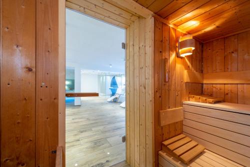 a sauna with wood paneling and a large window at Gästehaus Holzer in Konstanz