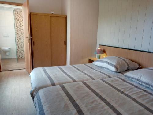 a bedroom with a large bed and a bathroom at Harz meets friends in Hasselfelde