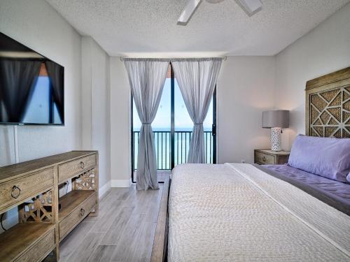 a bedroom with a bed and a view of the ocean at Madeira Towers 802 Renovated Madeira Towers Beachfront 2 Bedroom 2 Bathroom Condo 23143 in St Pete Beach
