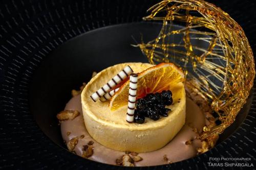 a dessert with a candle on top of it at Фетрбуш in Nadvirna