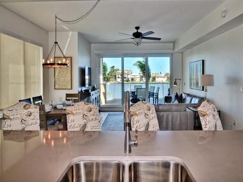 a kitchen and living room with a sink and a living room at Sandpiper's Cove 201 Sandpiper's Cove Luxury 3 Bedroom 2 Bathroom 23132 in Clearwater Beach