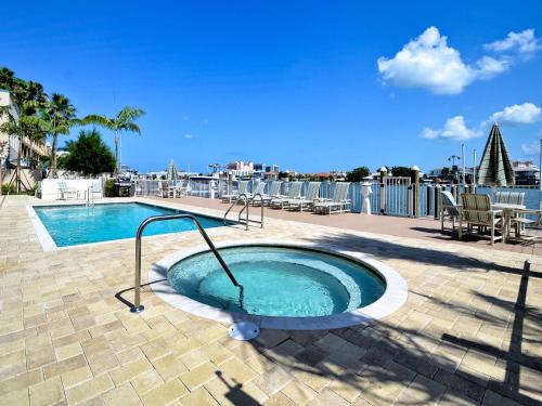 a pool with a hot tub on a patio at Sandpiper's Cove 201 Sandpiper's Cove Luxury 3 Bedroom 2 Bathroom 23132 in Clearwater Beach