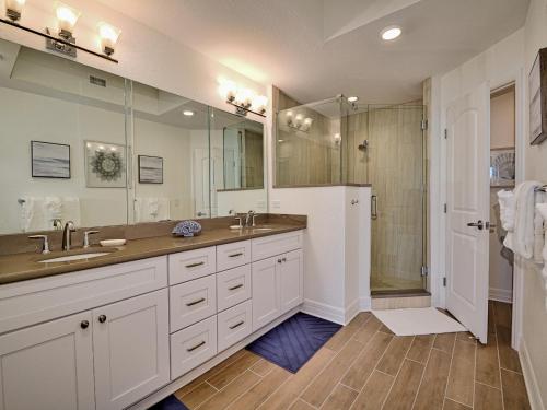 a bathroom with two sinks and a shower at Sandpiper's Cove 201 Sandpiper's Cove Luxury 3 Bedroom 2 Bathroom 23132 in Clearwater Beach