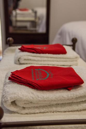 three piles of towels sitting on top of a bed at Casa FamiliarArtola Etxea San Sebastian-Pamplona-Bilbao in Baráibar
