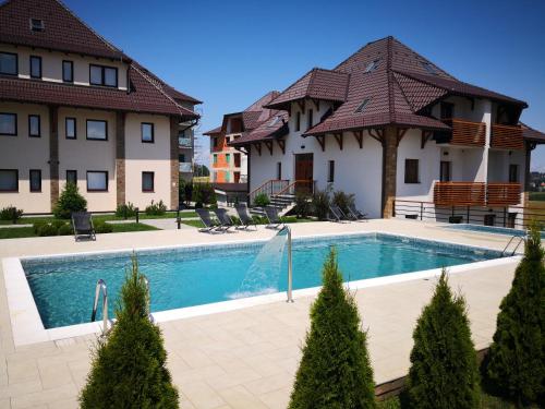 a swimming pool in front of a house at Sunset Zlatibor Hills in Zlatibor