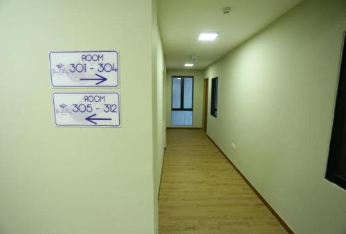 a hallway with signs on the wall of a building at Yeob Bay hotel Ampang in Ampang