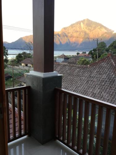 a balcony with a view of the mountains at The Villa's Kubu Sandan in Kintamani