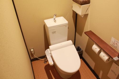 a bathroom with a toilet in a room at Koyado Enn in Toyooka