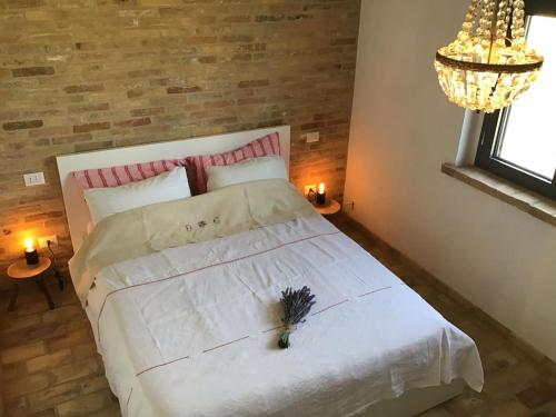 A bed or beds in a room at Il Melograno House