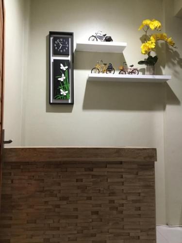 a room with shelves and flowers on the wall at The Villa's Kubu Sandan in Kintamani