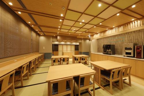 a room with tables and chairs in a kitchen at Onyado Nono Asakusa Natural Hot Spring in Tokyo