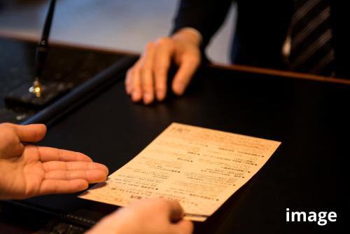 a person holding a piece of paper on a table at Onyado Nono Asakusa Natural Hot Spring in Tokyo