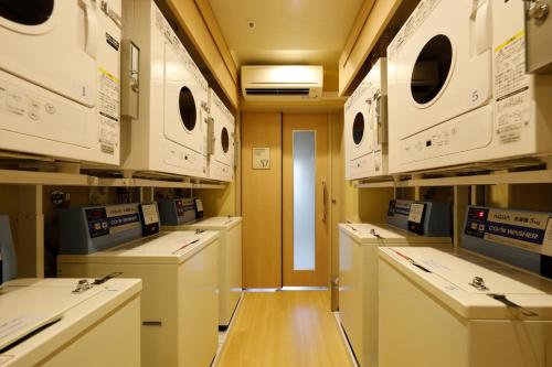 a room with a row of washers and dryers at Onyado Nono Asakusa Natural Hot Spring in Tokyo