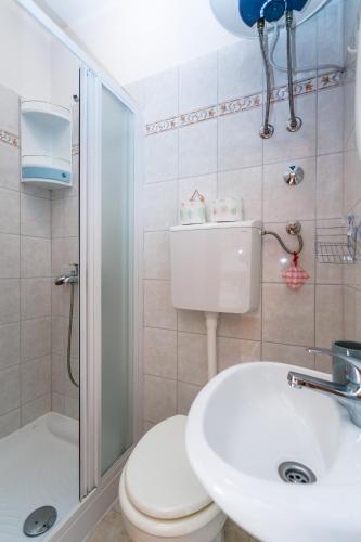 a bathroom with a toilet and a sink and a shower at Holiday House Snjezana in Krk