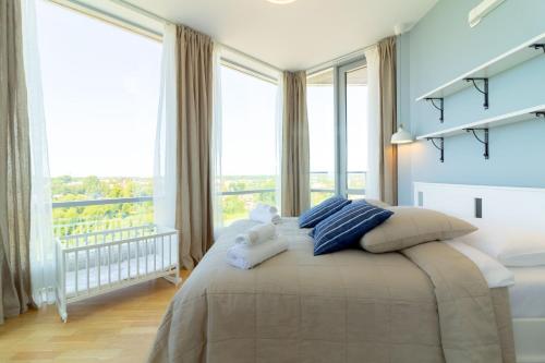 a bedroom with a bed with two teddy bears on it at Elija Swan-Toy Apartments in Šventoji