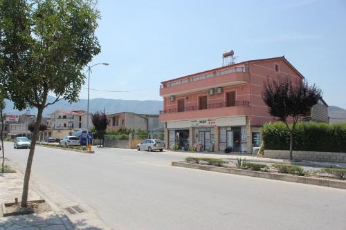 a red building on the side of a street at Guesthouse Leo in Berat