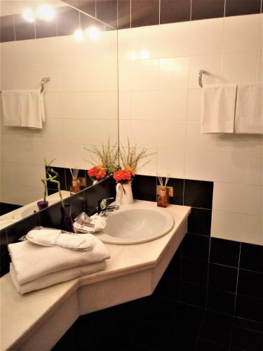 a bathroom with a sink and a mirror at HOTEL DOZZA in Dozza