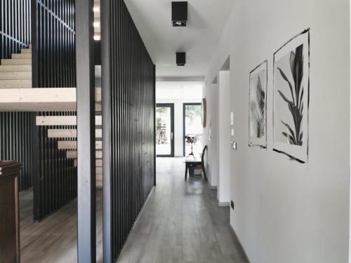 a hallway of a house with white walls and a staircase at Affittacamere Casa Ester in Baselga di Pinè