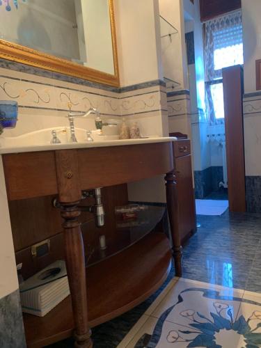 a bathroom with a sink and a mirror at I Citri in Taranto