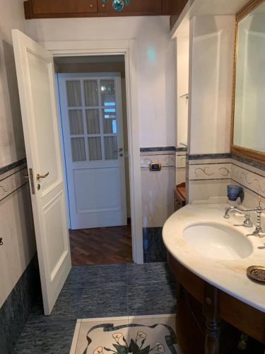 a bathroom with a sink and a mirror and a door at I Citri in Taranto