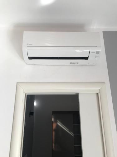 a air conditioner on the ceiling of a bathroom at Rooftop big Terrace fiera MIlano/Portello in Milan