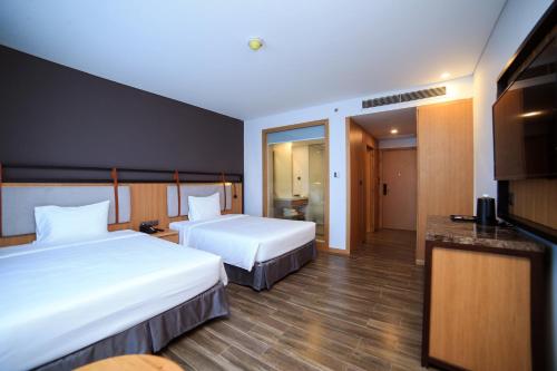 Ένα ή περισσότερα κρεβάτια σε δωμάτιο στο Dragon Style Hotel