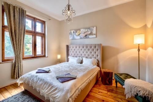a bedroom with a bed and a chandelier at Central High class 3 Bedroom Apartment in Sofia