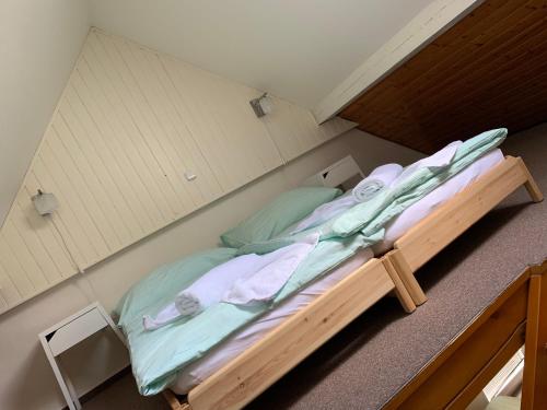 a large bed in a small room with at Penzion & Restaurace U Vily in Sezimovo Ústí