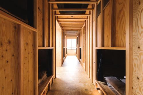 a hallway in a house with wooden walls at WhyKumano in Nachikatsuura