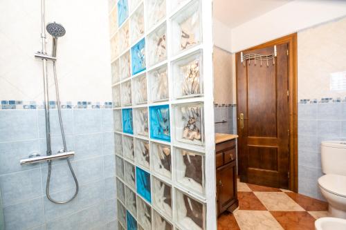 a bathroom with a shower and a toilet at Cubo's Finca el Cortijito de Herrera in Alhaurín el Grande