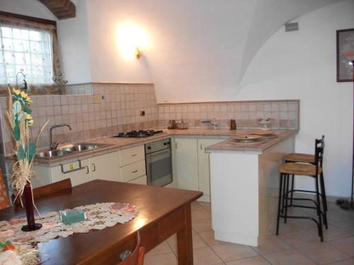 a kitchen with a sink and a counter top at APPARTAMENTO AURORA Val di Sogno in Malcesine