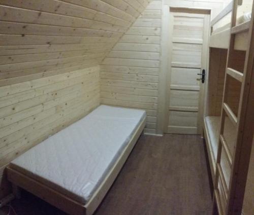 a small room with a bed in a room at PANORAMA RANČ in Ježíci