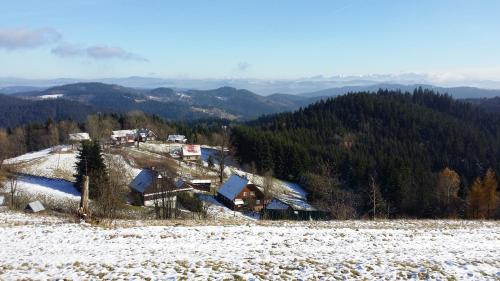 a group of houses on a hill in the snow at PANORAMA RANČ in Ježíci