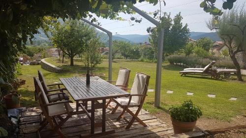 a wooden table and chairs in a garden at Wine cellar room in Vipava