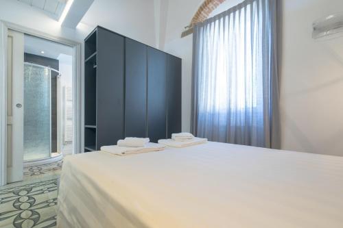 Ένα ή περισσότερα κρεβάτια σε δωμάτιο στο Giglio Apartments by Mmega