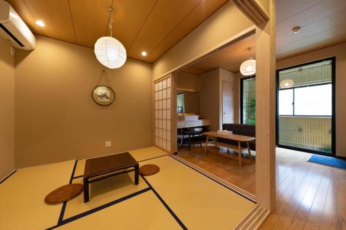 a living room with a table and a dining room at Shirakabanoyado - SHIOKUSA, 白樺の宿 - 塩草 in Osaka
