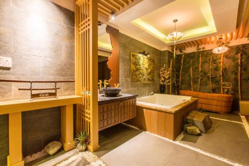 a large bathroom with a tub and a sink at Minh Tam Hotel and Spa in Ho Chi Minh City