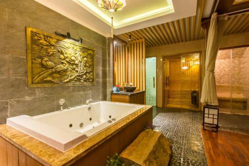 a large bathroom with a large tub and a shower at Minh Tam Hotel and Spa in Ho Chi Minh City