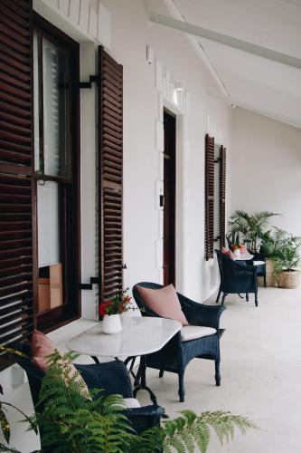 a patio with chairs and a table on a building at Heritage House in Stellenbosch