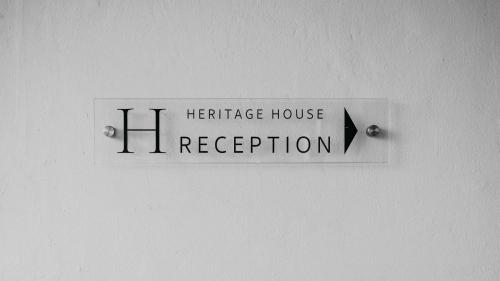 a healthcare house registration sign on a wall at Heritage House in Stellenbosch