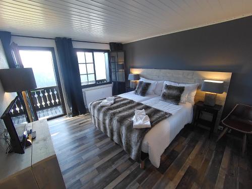 a bedroom with a large bed and two lamps at Champoussin Lodge in Champoussin