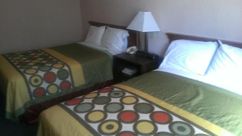 a hotel room with two beds and a lamp at Quality Inn in West Haven