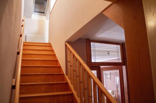 a staircase in a house with wooden floors at Hotel U Labutě in Žďár nad Sázavou