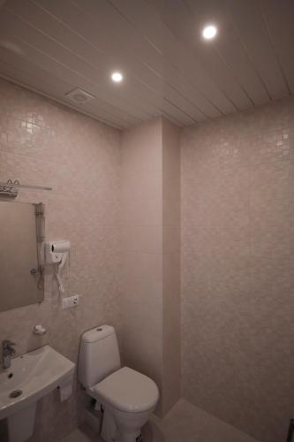 a bathroom with a toilet and a sink at Black Sea Riviera Hotel in Shekhvetili