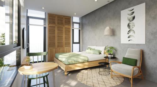 a bedroom with a bed and a table and a chair at Lem's Apartment & Coffee in Da Nang