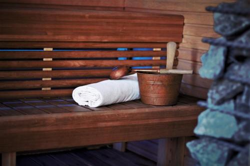 a roll of toilet paper and a bucket on a bench at Mileikių sodyba namelis dviems in Šarkiškės
