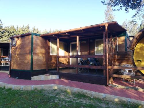 a modern house with a wooden facade at Camping Valle dei Templi in San Leone